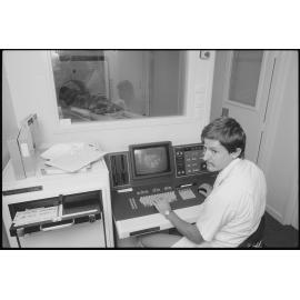 Unidentified Radiographer operating a CT scanner, Ipswich, July 1985