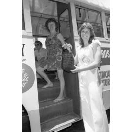 Unidentified Courtesy Maid helping woman boarding a bus, Ipswich, November 1977