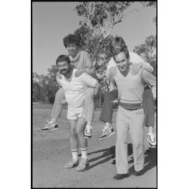 Two unidentified couples getting a piggyback ride from their partners, Ipswich, July 1985