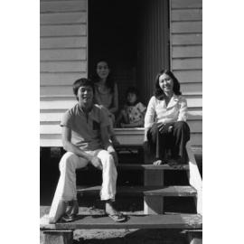 Unidentified family sitting on steps, Ipswich, November 1977