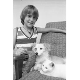 Unidentified child with pet dog and cat, Ipswich, February 1978