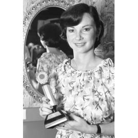 Unidentified hairdresser displays her award, Ipswich, February 1978