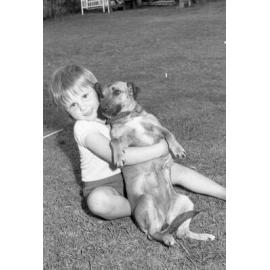 Troy Preston playing with his dog, Tina, Ipswich, 7th October 1977