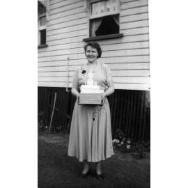 Unidentified woman with 21st birthday cake, Ipswich, c.1952