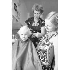 Little boy having his first hair cut Clarkia Salon, Ipswich, February 1978