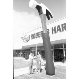 Thought to be John and Margaret Roberts with Giant Hammer outside Roberts Hardware Store, Bundamba, Ipswich, March 1978