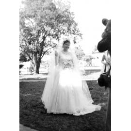 Unidentified bride posing for photographs in a park, Ipswich, 1950-1955