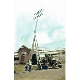 Erecting a power pole in front of Proudlock's store at Marburg, Ipswich, early 1920s