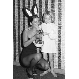 Easter Bunny offering little girl a chocolate Easter Egg, Ipswich, March 1978