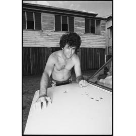 Unidentified man with car in yard, Ipswich, January 1986