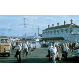Workers leaving the main gate of the Ipswich Railway Workshops located at the intersection of Delacy and North Streets, Ipswich, 1969