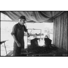 Unidentified man blacksmithing at Laidley Pioneer Village and Museum, Laidley, 1986