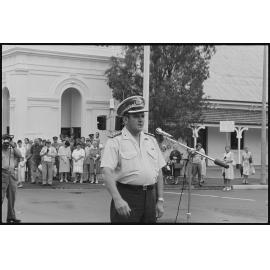Unidentified Queensland Police officer halting the crew of H.M.A.S. Ipswich as they marched along Brisbane Street, requesting 'Freedom of Entry to the City', Ipswich, January 1986