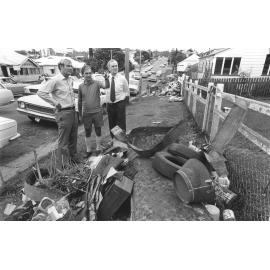 Country Party Leader Doug Anthony, Member for Ipswich Sir Llew Edwards, and State Lands Minister Wally Rae inspecting flood damage in South Street, Ipswich, January 1974