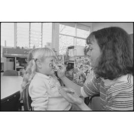 Unidentified child getting her face painted, Ipswich, July 1985
