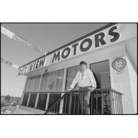 Mark Cumming standing at a City View Motors storefront, Ipswich, July 1985
