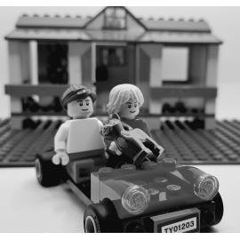 Brickswich version of children on toy car in backyard at 7 Alice Street, Blackstone, late 1940s