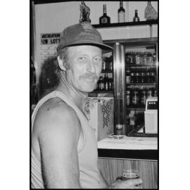 Unidentified man holding a beer at a bar, Ipswich, January 1986