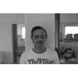 Employee at Jeff Denman's Tyre & Auto Service wearing a 'The Fijian' shirt, Ipswich, August 1980