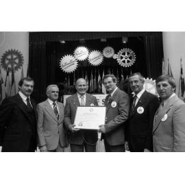 Unidentified men stand with John Dobson, George Skippen, and John Beitzel, thought to be at the Charter Night Celebration for the formation of Goodna Rotary Club, Ipswich, August 1980