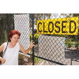 Unidentified woman at Department of Transport closed sign, Ipswich, December 2003