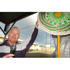 Ken Farquharson spins the ham wheel during the Christmas Carnival at Marburg, Marburg, December 2003