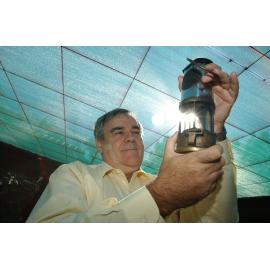 Stewart Bell (director) holding a miner's safety lamp, Ipswich, September 2003