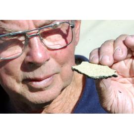 Unidentified man holding a piece of stone, Ipswich, September 2003
