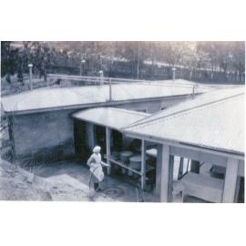 Nurse hosing laundry, Old Epidemic Ward, c1930s