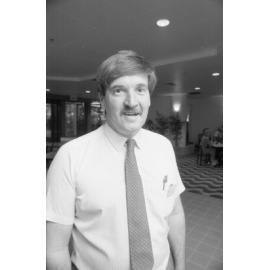 Unidentified man standing in a dining area at the opening of Ipswich City Square, Ipswich, August 1987 