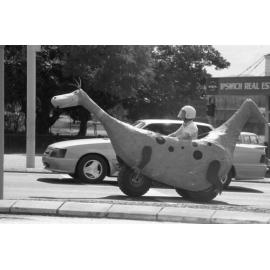 Dino the Snorkasaurus of the Flintsones parade float travelling in the Mall to Mall event to celebrate the opening of Ipswich City Mall, Ipswich, August 1987