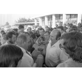Thought to be Vincent Klein speaking with an unidentified in a crowd at the Shell Roadhouse Meeting, Gailes Ipswich, September 1980