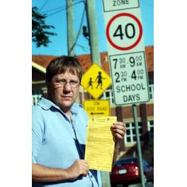 Les Bounds holding a speeding fine ticket at North Ipswich School Zone, Ipswich, June 2003