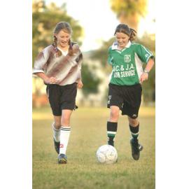 Janiene Smith and Teagan Essom playing soccer, Ipswich, June 2003