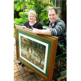 Gayle Brockie and Gordon Hanley holding a painting at an art auction, Ipswich, June 2003
