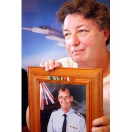 Sue Cross holding an image of an unidentified Royal Australian Air Force Deseal/Reseal, Ipswich, February 2003 