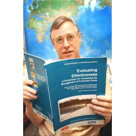Marc Hockings reading a book on wildlife at the University of Queensland, Gatton, March 2003