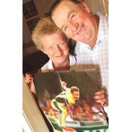 Shirley and Trevor Bichel holding a poster of their son, Australian cricketer Andy Bichel, Ipswich, March 2003