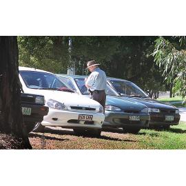Officer giving out parking fines at the hospital, Ipswich, April 2003
