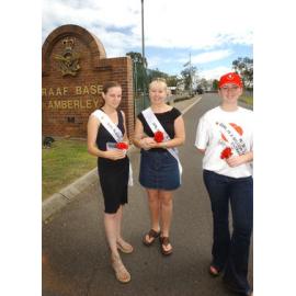 RSL Girl in a Million entrants, Tara Tate, Maree Lutter and Katie Smith, selling poppies before Remembrance Day at the front gate of RAAF Base Amberley, Ipswich, November 2003