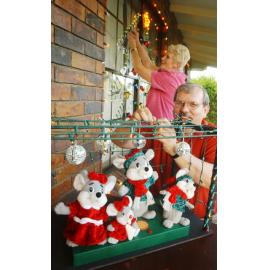 Unidentified man and woman putting up Christmas lights and decorations, Ipswich, November 2003
