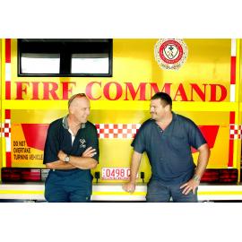 Mark Thompson and Steve Arnold leaning against a fire truck, Ipswich, August 2003