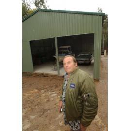 Trevor Aylott in front of a garage, Ipswich, August 2003
