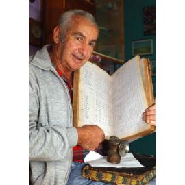Tom Verrall holding a book on historic mining projects, Ipswich, August 2003