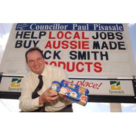 Ipswich Mayor Paul Pisasale holding Dick Smith products in front of a Dick Smith sign, Ipswich, May 2003