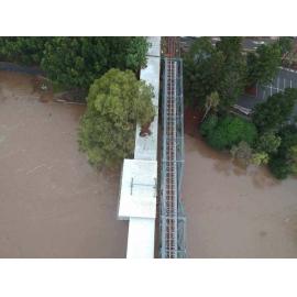 Drone images of the Bremer River in flood under railway and Bradfield bridges, Ipswich, March 2025