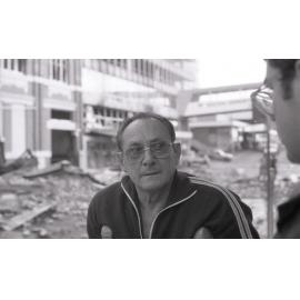Man viewing the aftermath of the Reid's (Cribb & Foote) fire, Bell Street, Ipswich, August 1985