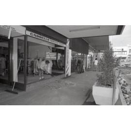 Cleaning-up broken glass from the shop window of Cassells clothing store, in the aftermath of the Reid's (Cribb & Foote) fire, Bell Street, Ipswich, August 1985