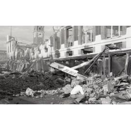 Man inspecting the aftermath of the Reid's (Cribb & Foote) fire, Bell Street, Ipswich, August 1985