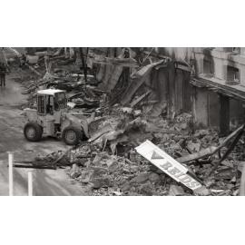 Bulldozer cleaning up the street of rubble, in the aftermath of the Reid's (Cribb & Foote) fire, Bell Street, Ipswich, August 1985